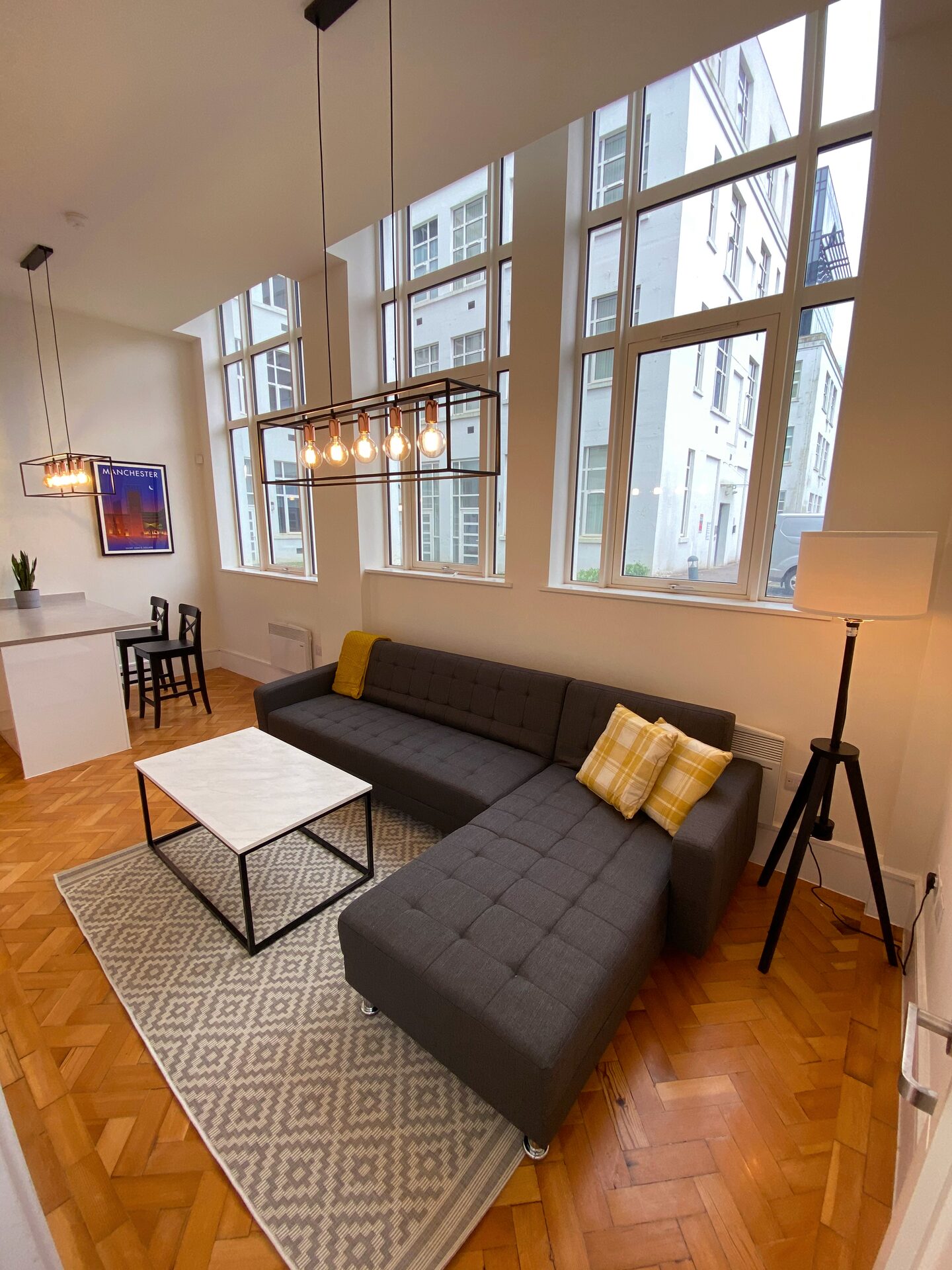 Stunning duplex apartment living area with high ceilings and large windows